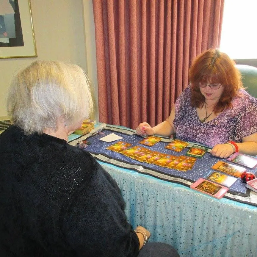 In-person tarot reading with a client at Rev. Berta Kay's table in Fultonville, NY